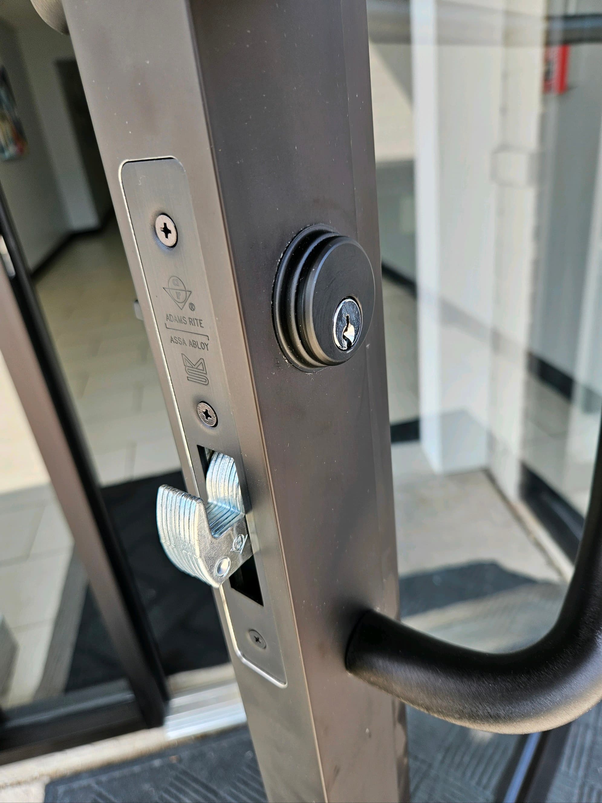 Adams Rite ASSA ABLOY commercial lock mechanism close-up, professional commercial locksmith hardware installation in Rockville MD
